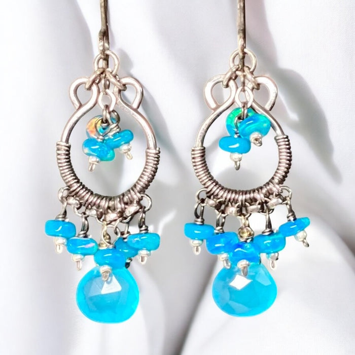 Pair of earrings with turquoise beads on a white background