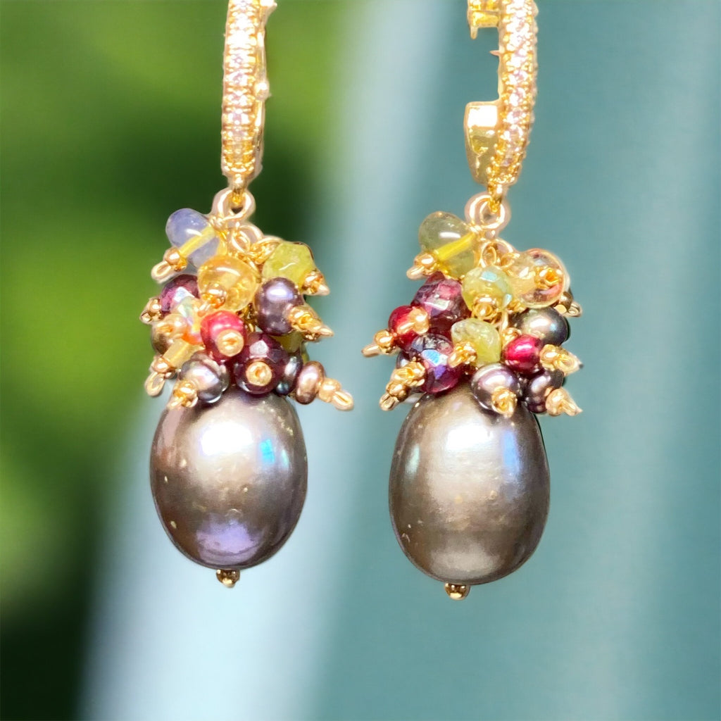 Grey freshwater pearls dangle beneath clusters of fall and holiday hued gemstones on gold filled wires: citrine, vesuvianite, garnet, cranberry pearls and opals