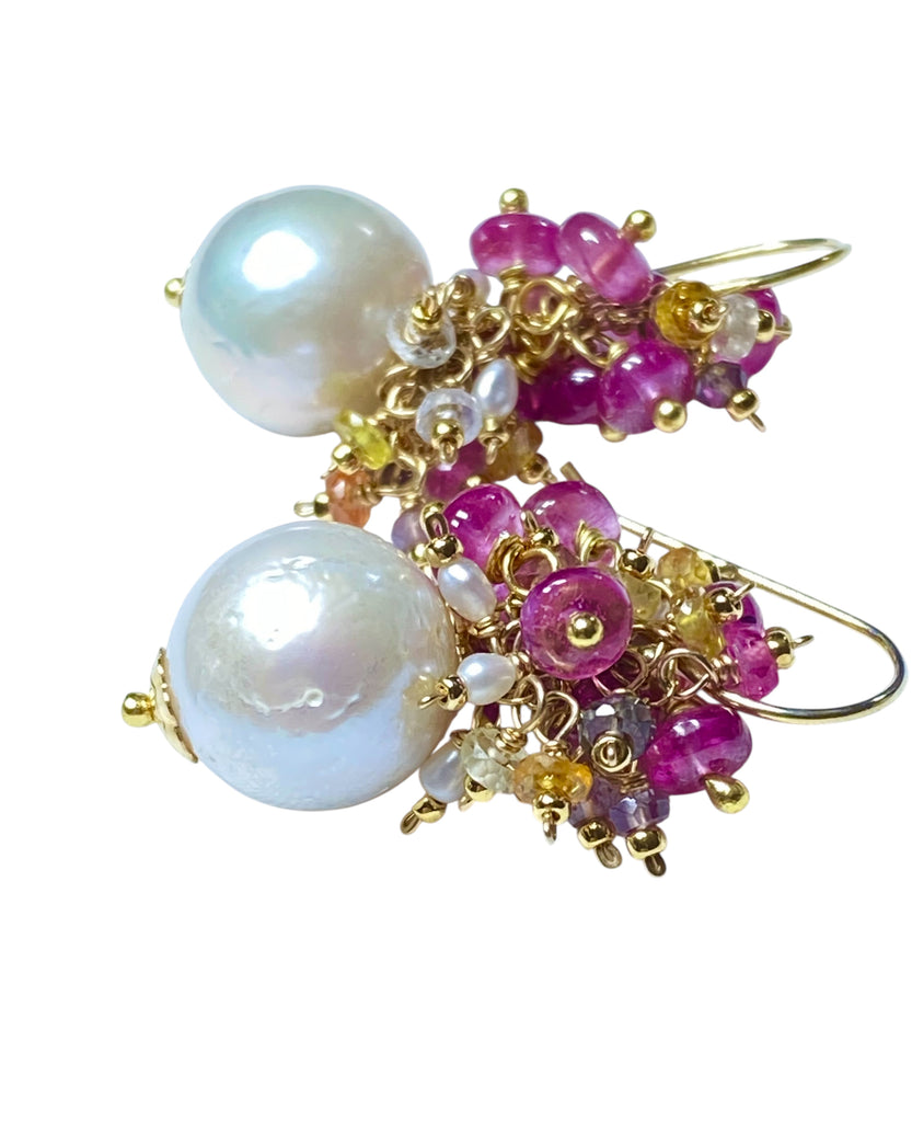 Pearl and pink sapphire cluster earrings gold lying on white background - clean product photography
