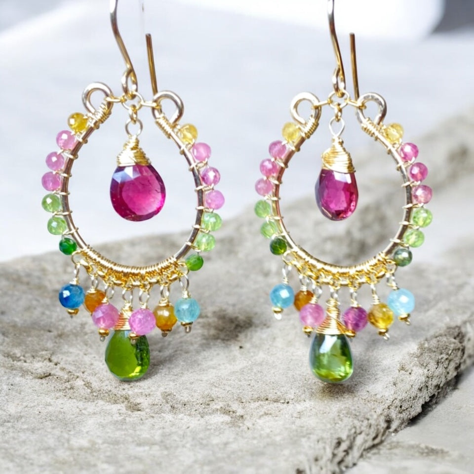 Multicolor tourmaline chandelier hoop earrings gold fill dangling over beige marble slab