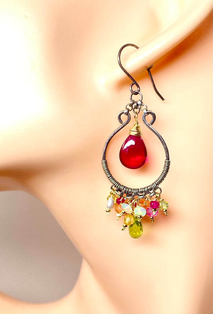  Oxidized silver hoop earrings with pink and green gems on mannequin