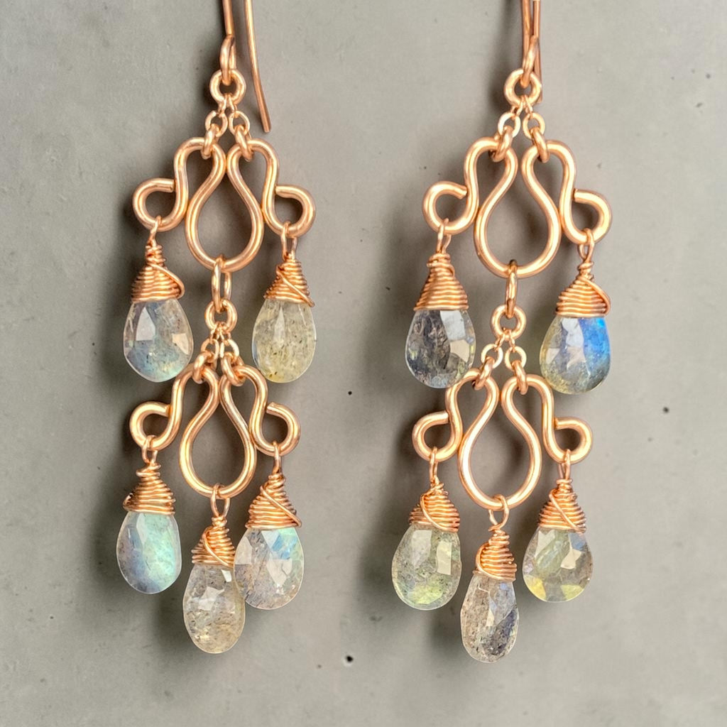 Rose gold-filled double chandelier earrings against pale grey, showing curled frames and wire-wrapped labradorite teardrops.