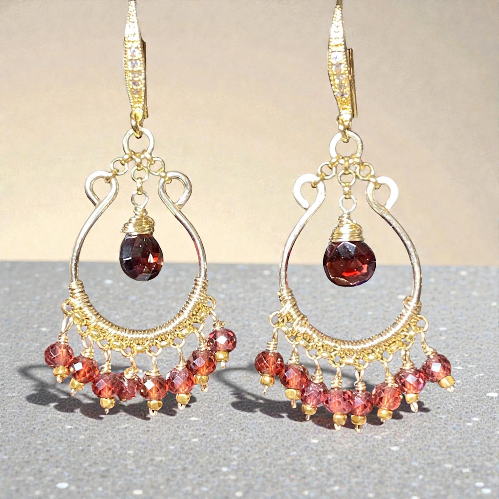 Red garnet chandelier hoop earrings 14kt gold fill in front of grey and beige minimalist background