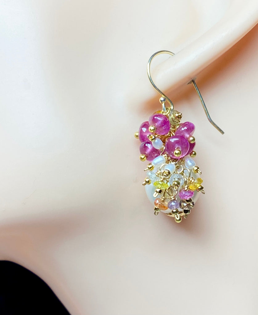Pearl and pink sapphire cluster earrings gold on mannequin head showing length and drape