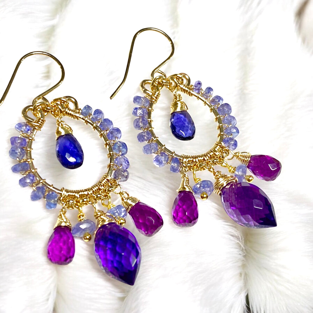 Tanzanite iolite amethyst violet quartz chandelier earrings in 14kt gold fill lying on white furry fabric showing statement earring detail