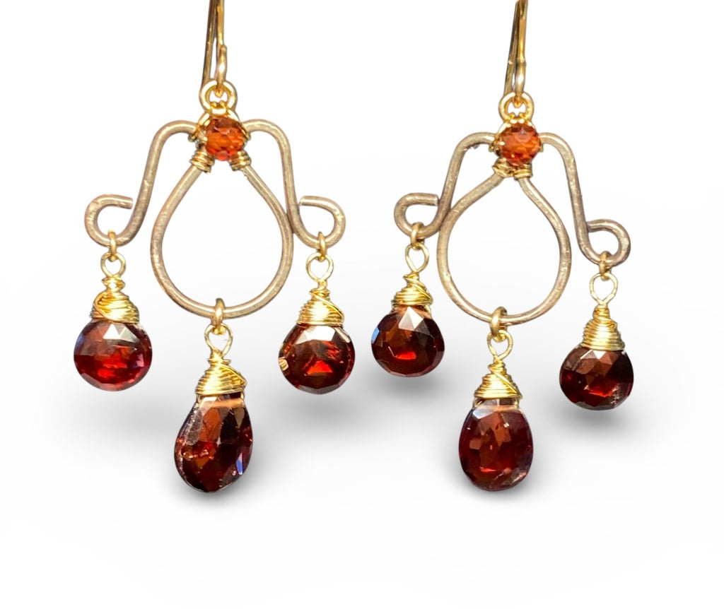 Oxidized silver chandelier earrings dangling red garnet faceted briolettes wire wrapped in 14kt gold fill wires shown in front of solid white background