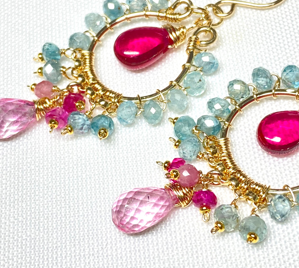  "Natural blue zircon and pink gemstone chandelier hoop earrings in 14K gold fill lying flat on white fabric"