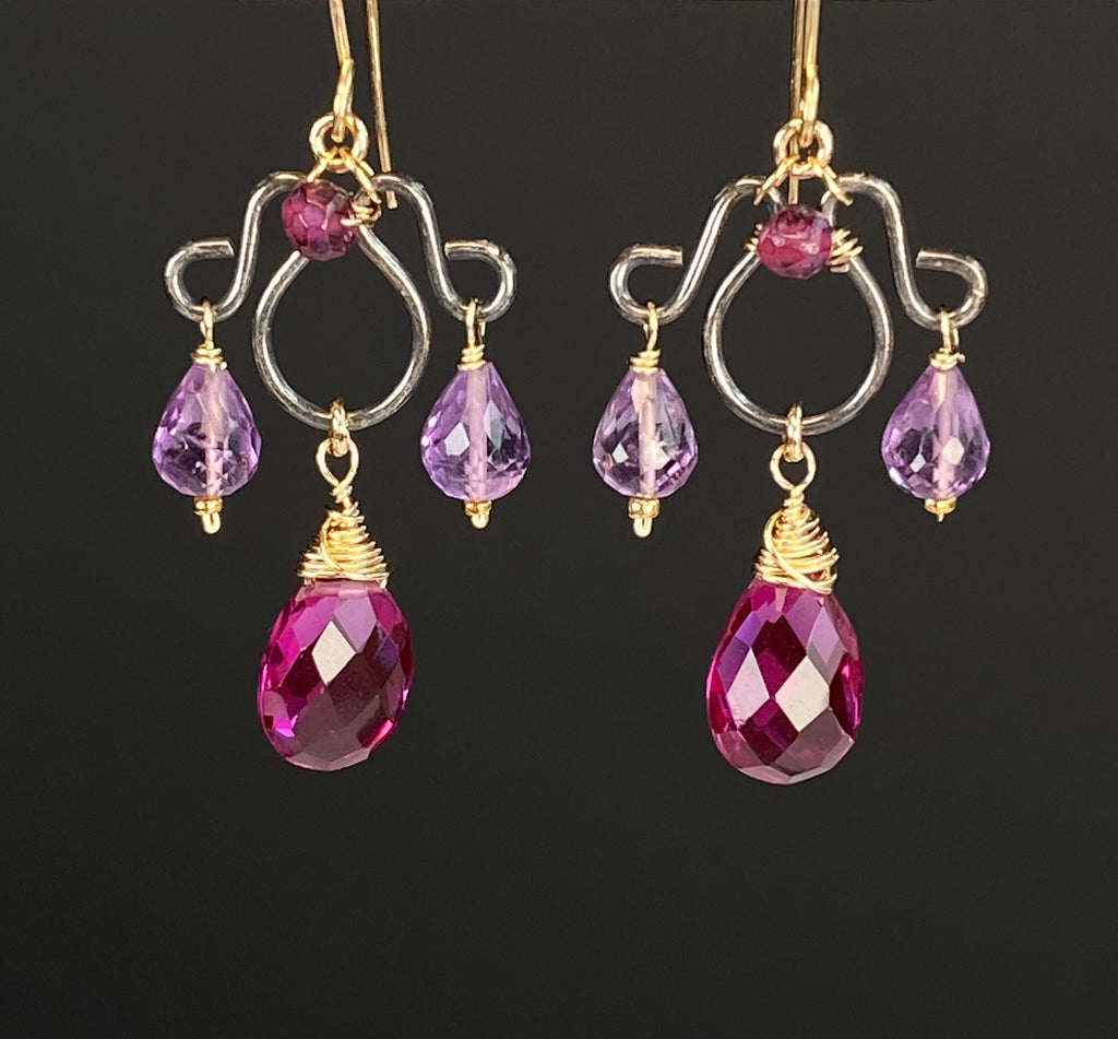 Close-up of faceted violet rhodolite drops and lavender amethyst accents with gold-filled wirework on oxidized sterling silver chandeliers.