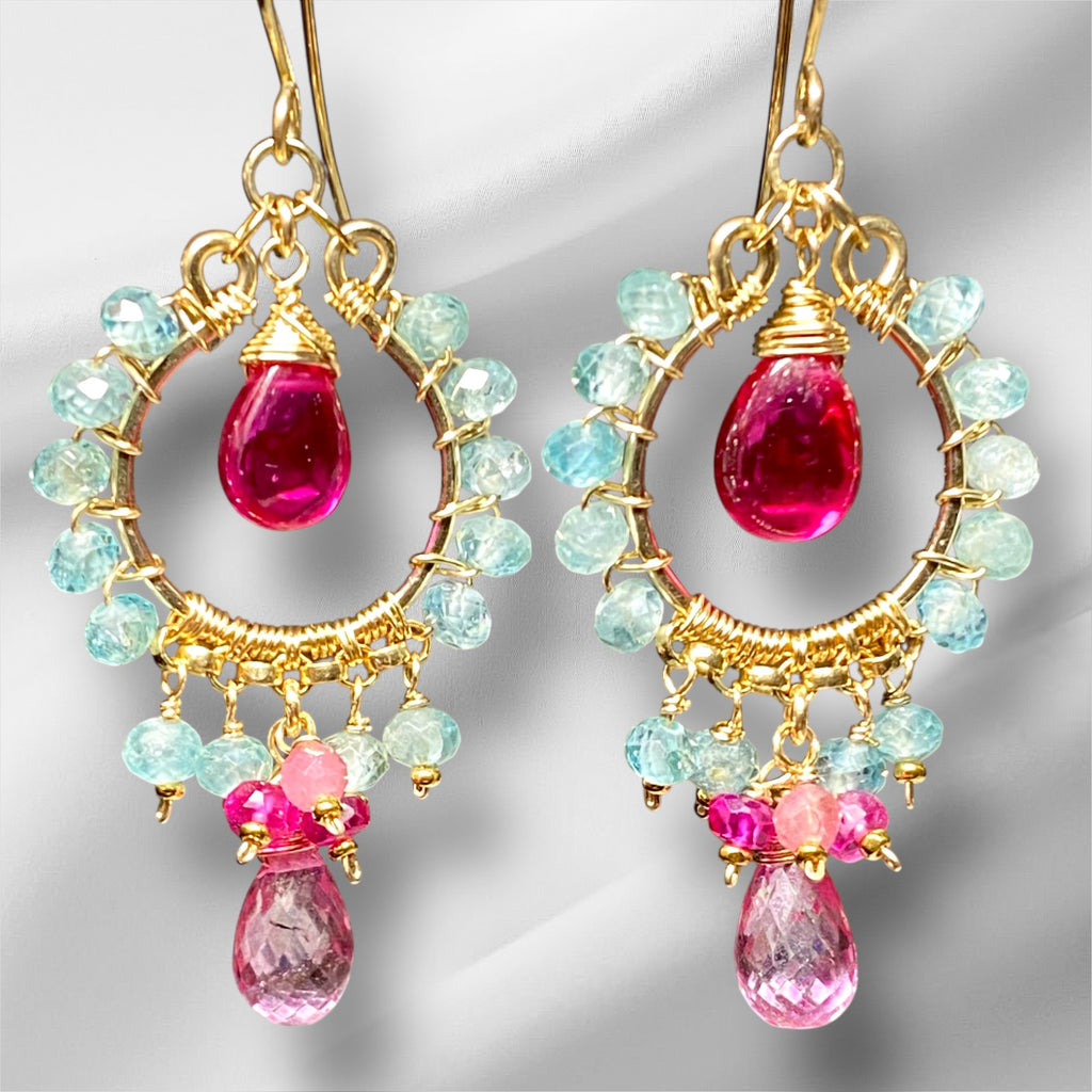 "Natural blue zircon and pink gemstone chandelier hoop earrings in 14K gold fill against white fabric background"