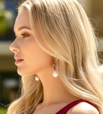 Blonde model headshot wearing ruby pearl cluster earrings pink tourmaline peridot aquamarine gold fill statement jewelry side view