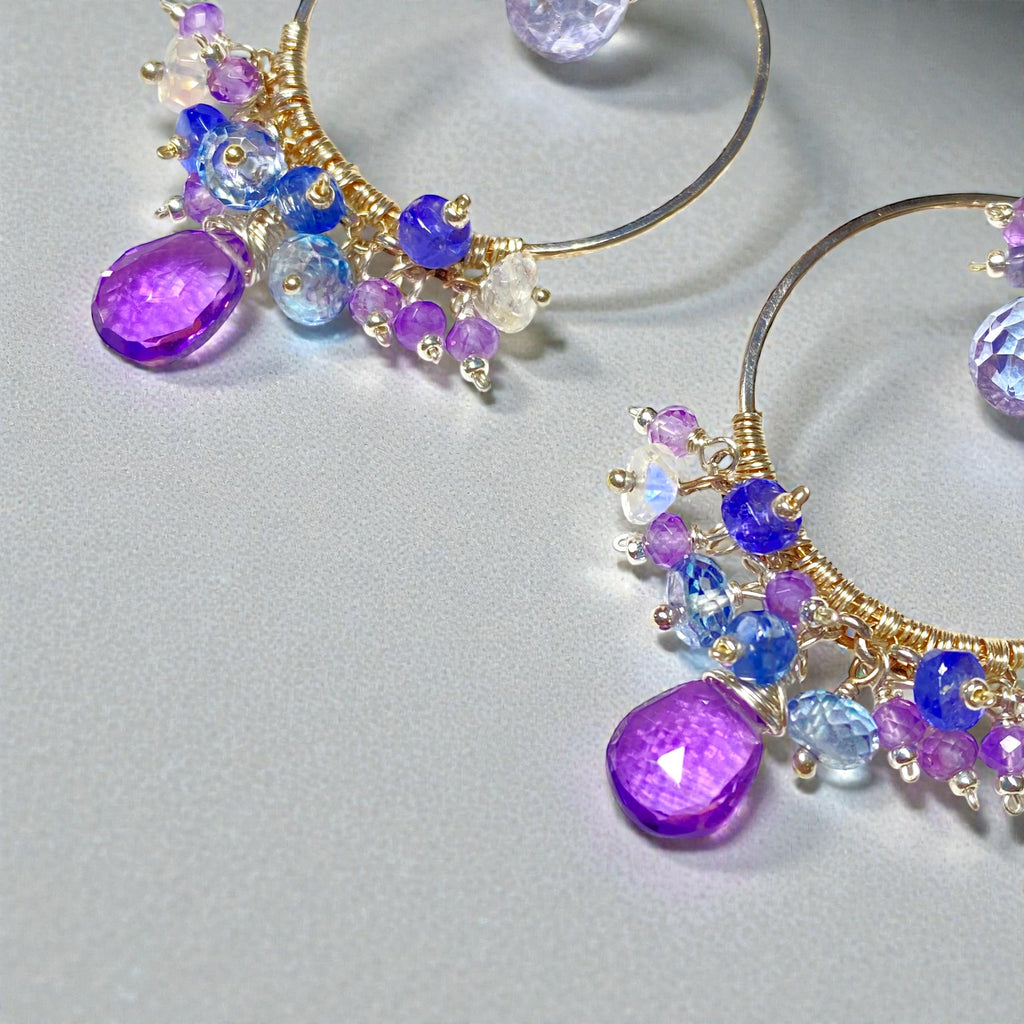 Colorful gemstone chandelier earrings amethyst tanzanite blue violet quartz bottom fringe of gemstones on grey background