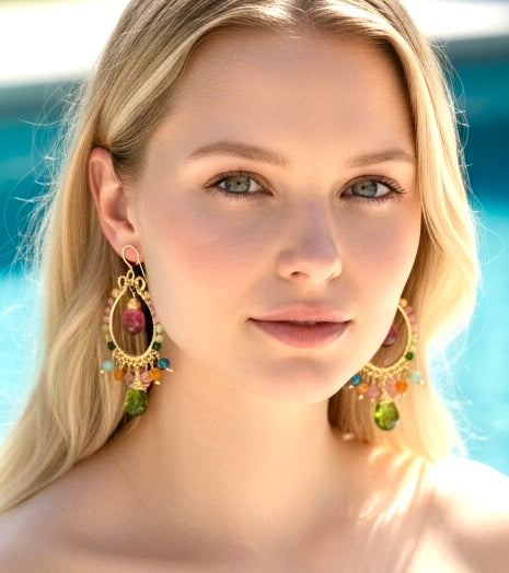 Multicolor tourmaline gold chandelier hoop earrings closeup on blonde model headshot at pool