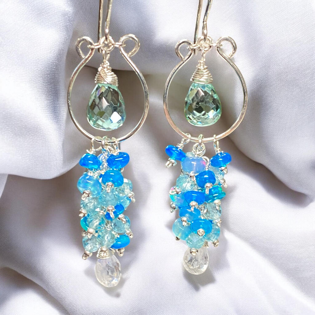 Sterling silver chandelier earrings with blue and green gemstones against white background.