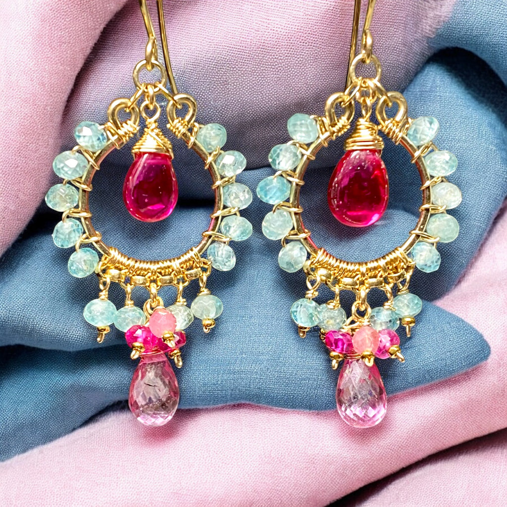 "Natural blue zircon and pink gemstone chandelier hoop earrings in 14K gold fill displayed against pink and blue draped fabric"
