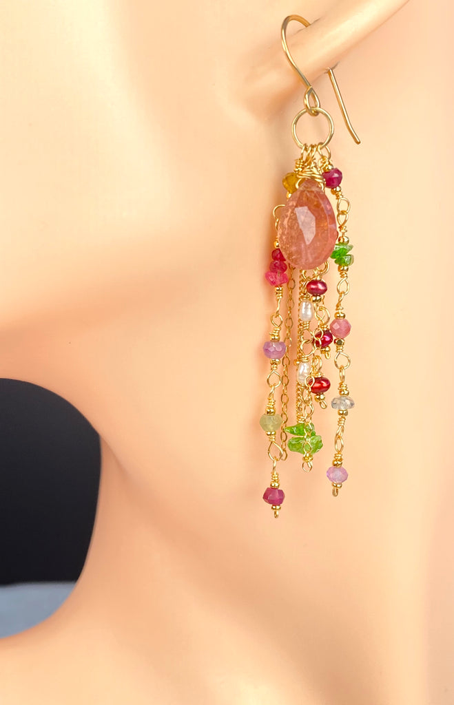 Long pink tourmaline earring shown on a display ear, illustrating the drop length and layered strands of multicolor gemstones and pearls in 14kt gold fill.