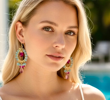 "Blonde woman wearing natural blue zircon and pink gemstone chandelier hoop earrings, poolside headshot"