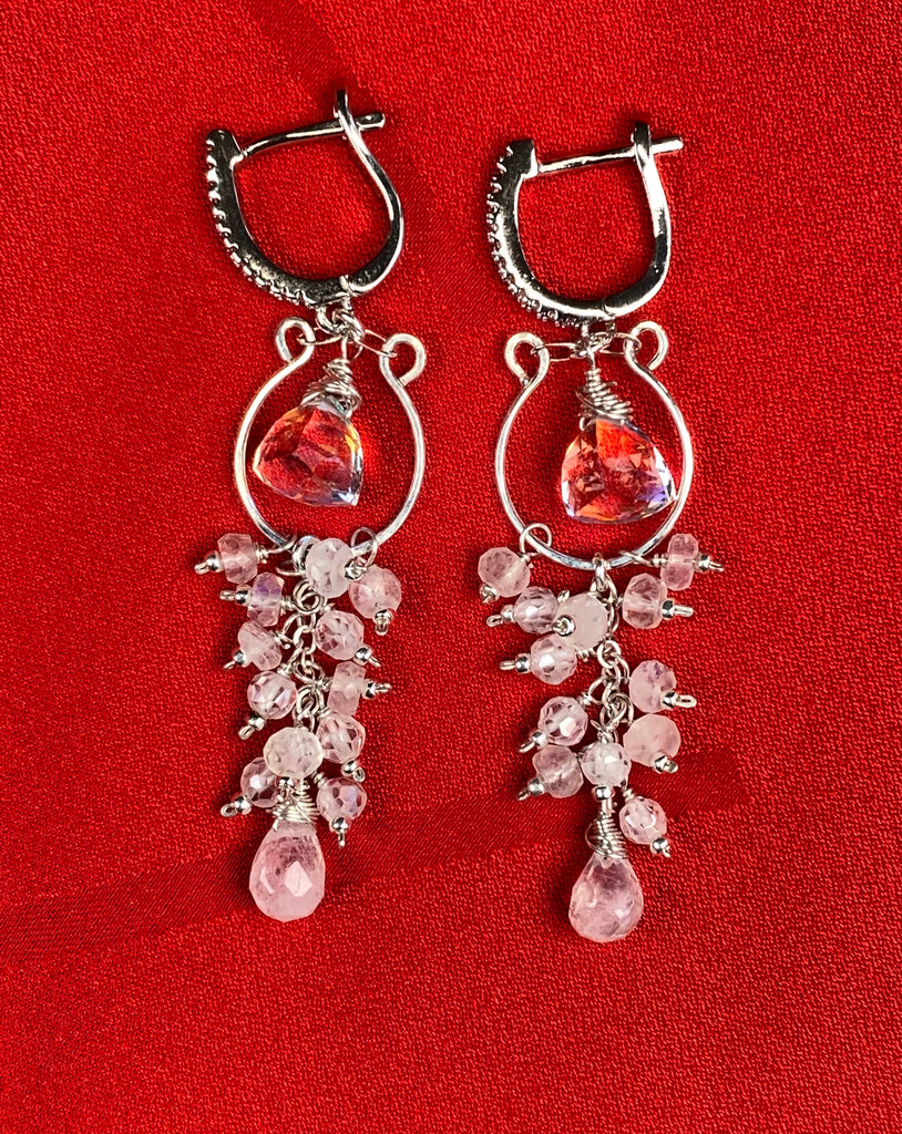 Rainbow quartz and moonstone tassel earrings on red fabric, showing lever-back closures and hand-forged sterling silver hoop forms.