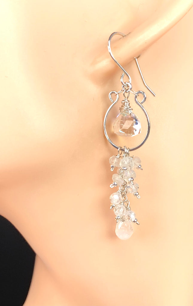 Rainbow quartz and moonstone tassel earring on a mannequin ear, showing its cascading shape and sterling silver French hook.