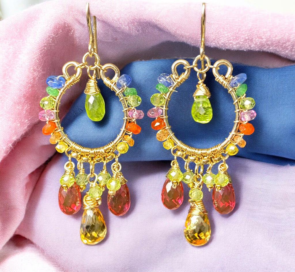 Colorful peridot citrine pink quartz chandelier earrings gold fill in front of blue white lavender folded fabrics