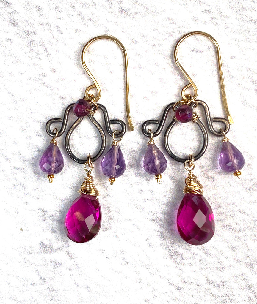 Front view of violet rhodolite and lavender amethyst chandelier earrings with gold-filled French hooks and dark gunmetal sterling silver frames.