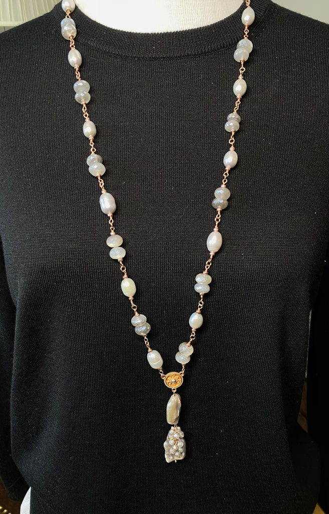 Rose gold grey pearl moonstone long necklace displayed on black sweater mannequin