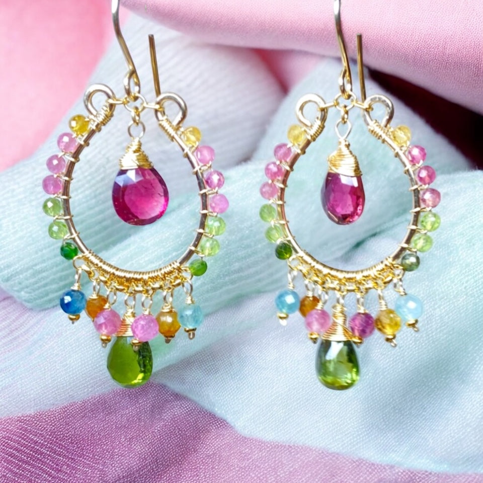 Multicolor tourmaline chandelier hoop earrings gold fill in front of draped pink and light blue fabrics
