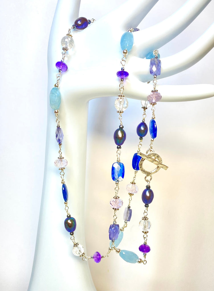 Blue purple gemstone peacock pearl long necklace sterling silver draped from mannequin arm hand between fingers