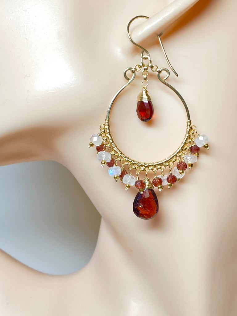 Red garnet and rainbow moonstone gold hoop earrings on mannequin with French hook ear wires