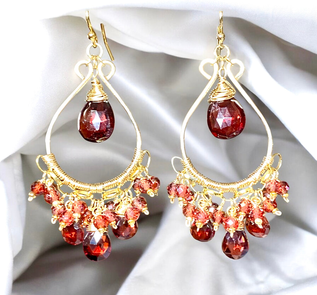Red garnet chandelier earrings 14kt gold fill over draped white fabric background