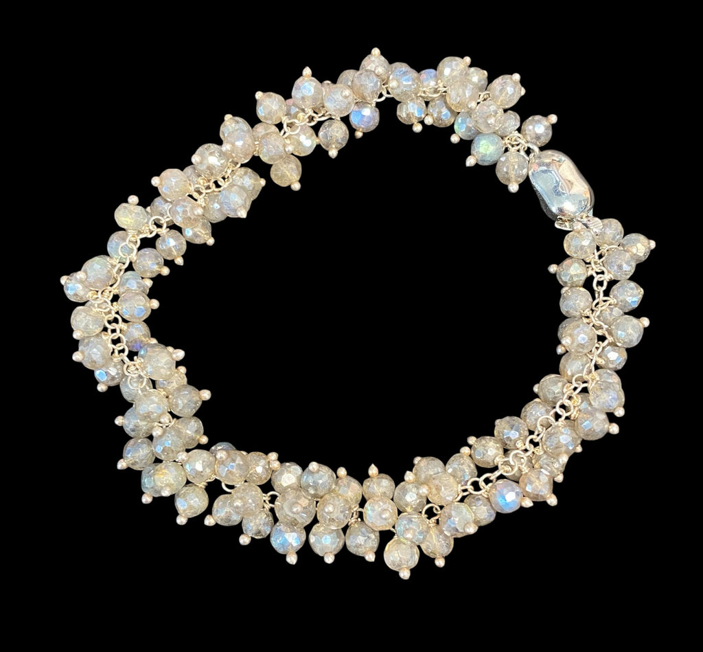  Mystic labradorite sterling silver cluster bracelet on plain black background