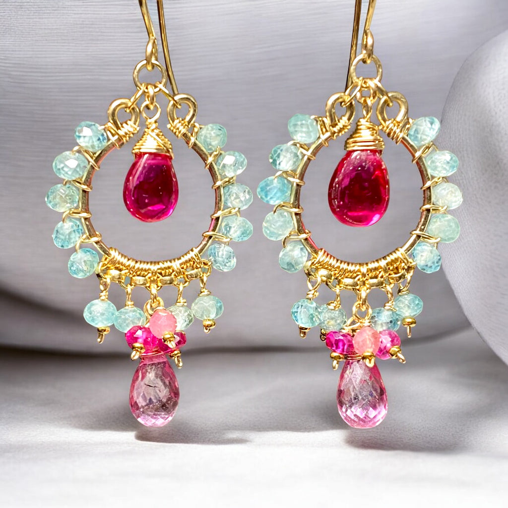 "Natural blue zircon and pink gemstone chandelier hoop earrings in 14K gold fill against white fabric background"