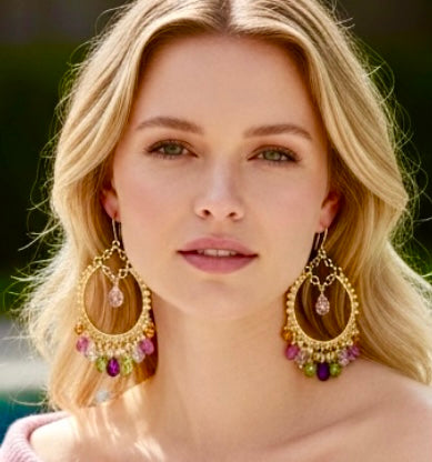 Headshot closeup of Model styling colorful amethyst, pink sapphire and mandarin garnet statement hoop earrings in 14kt gold fill