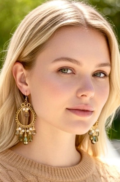 Blonde model wearing gold hoop earrings with pyrite and smokey quartz - close-up headshot showing earring detail"
