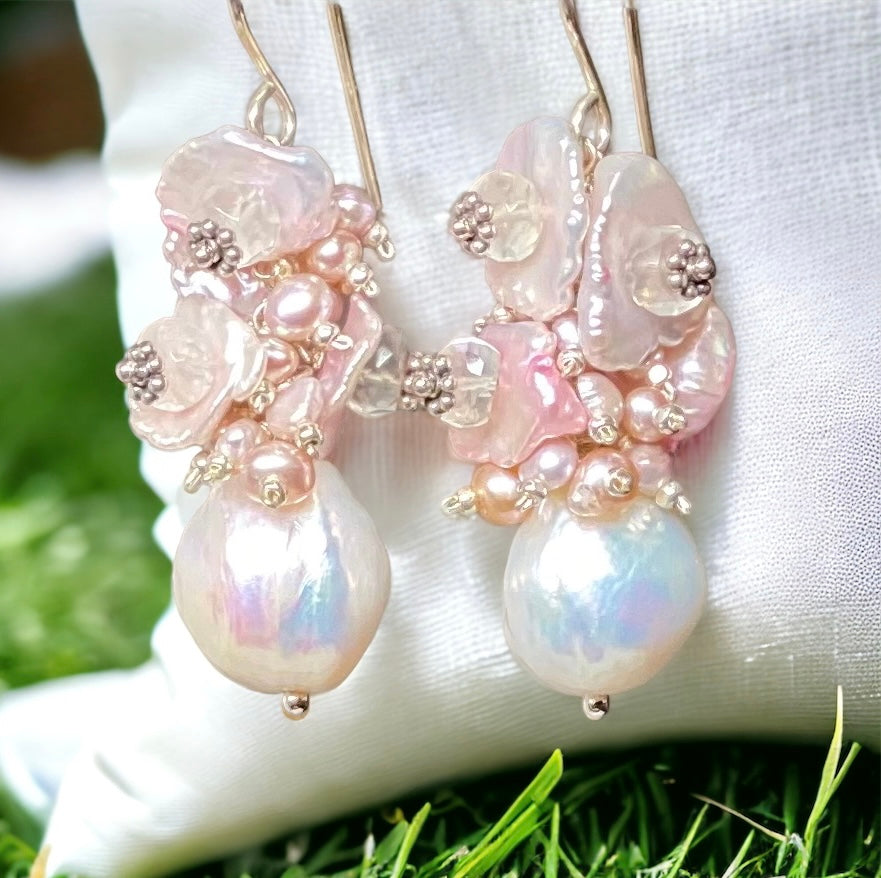 white Edison pearls with clusters of tiny pink cascading pearls and blush pink keishi pearls mounted with moonstones and silver Bali daisy spacers