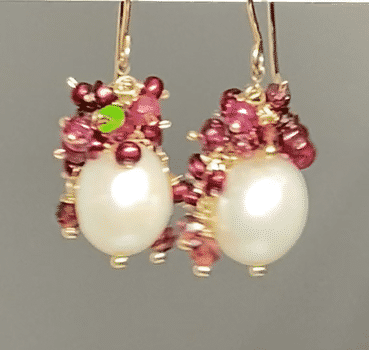 White pearls with clusters of red ruby, opal, pearls, garnets on gold