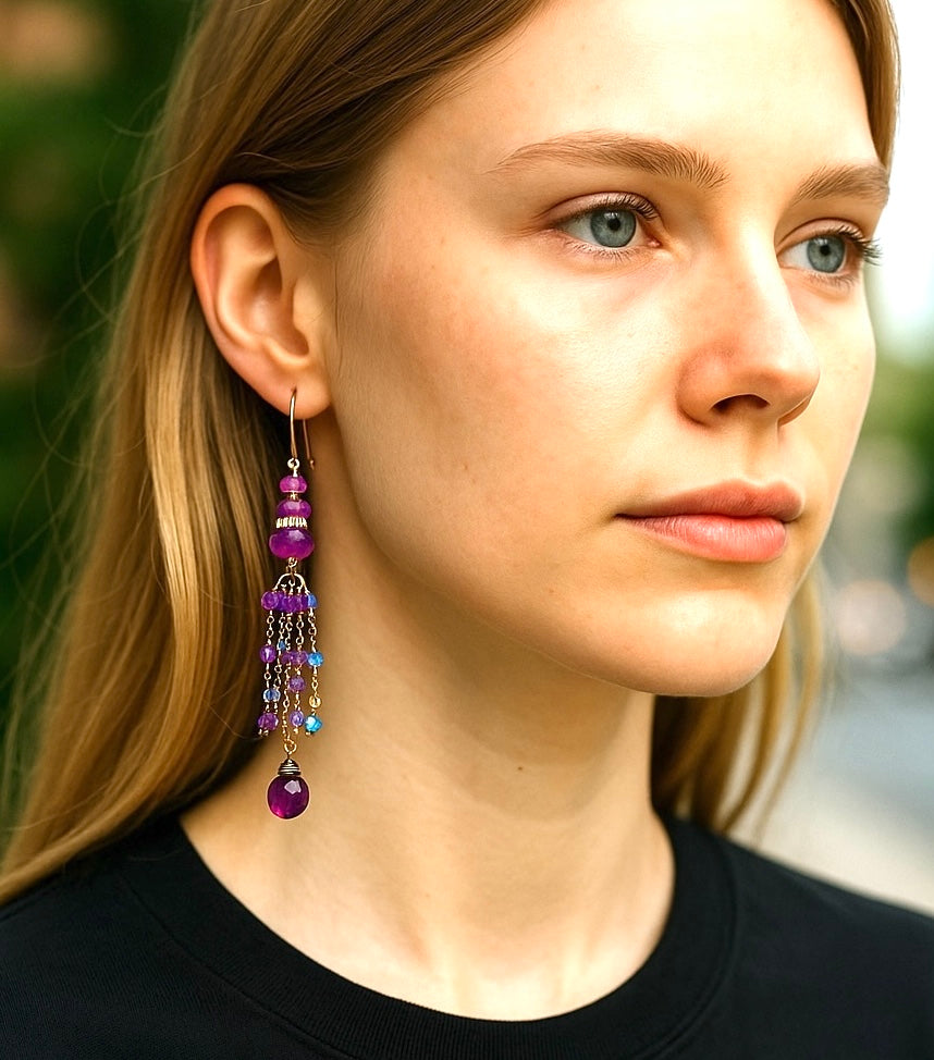 Close-up of a woman wearing colorful beaded earrings with a blurred background