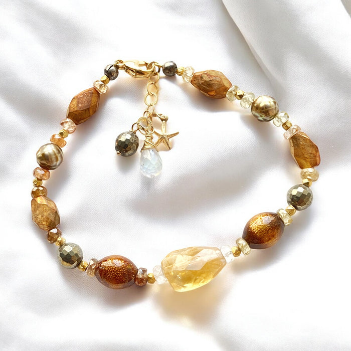Beaded bracelet with starfish charm on a white background