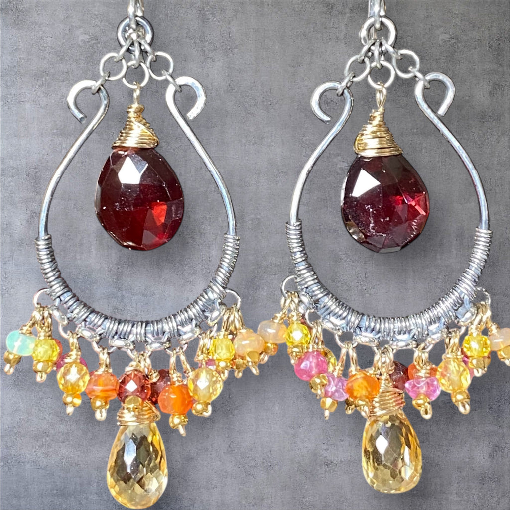 Red garnet citrine mixed metal hoop earrings on grey suede background