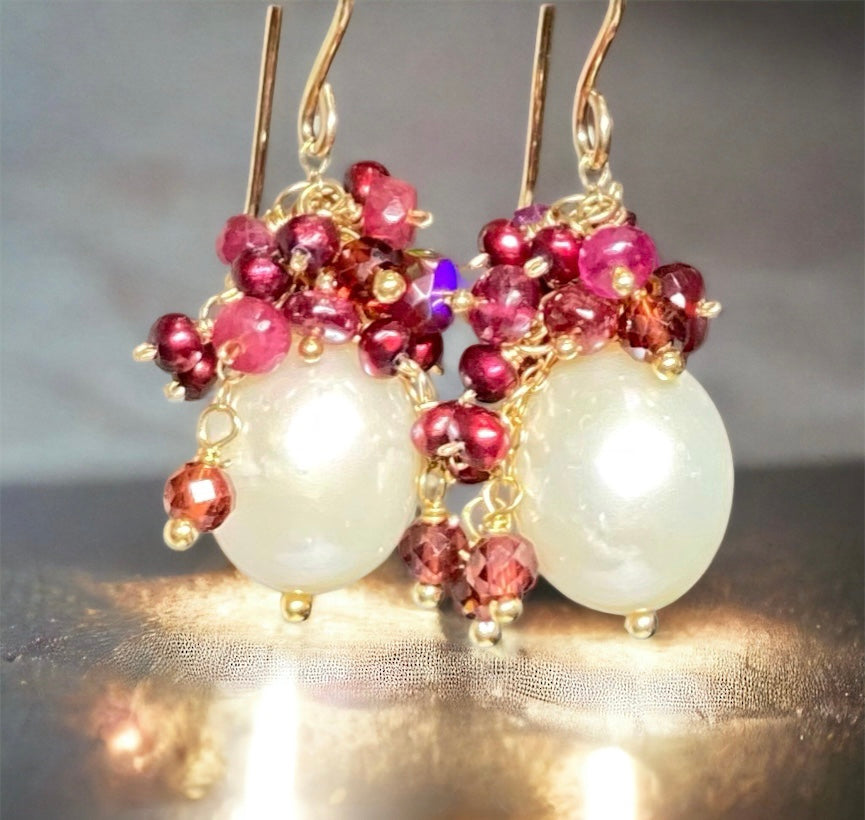 Ivory white pearls with cascading clusters of red pearls and gemstones
