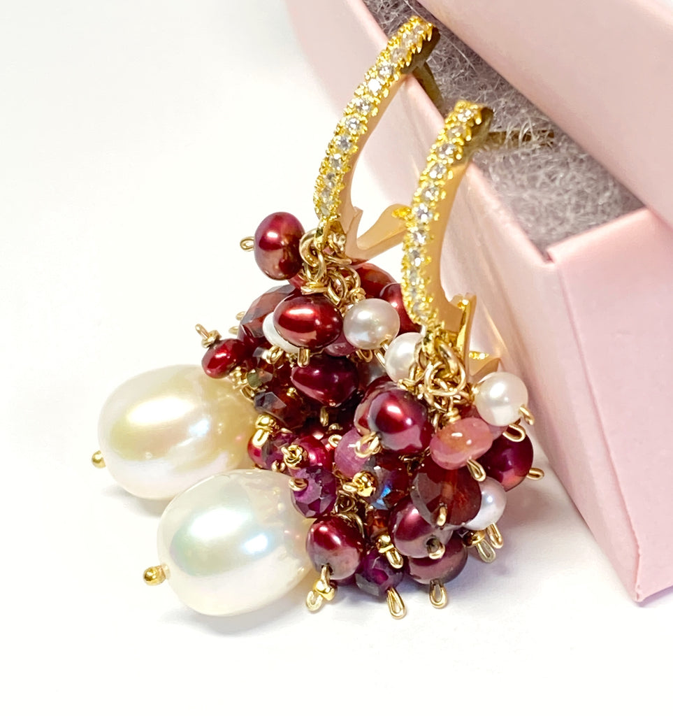 Holiday earrings with red pearls and gem clusters over white pearls