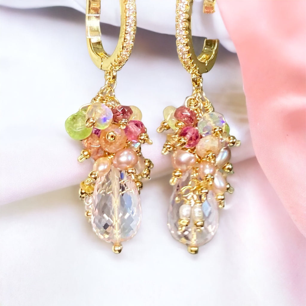 Clusters of tiny pearls and gemstones waterfall down over pink rose quartz drop earrings
