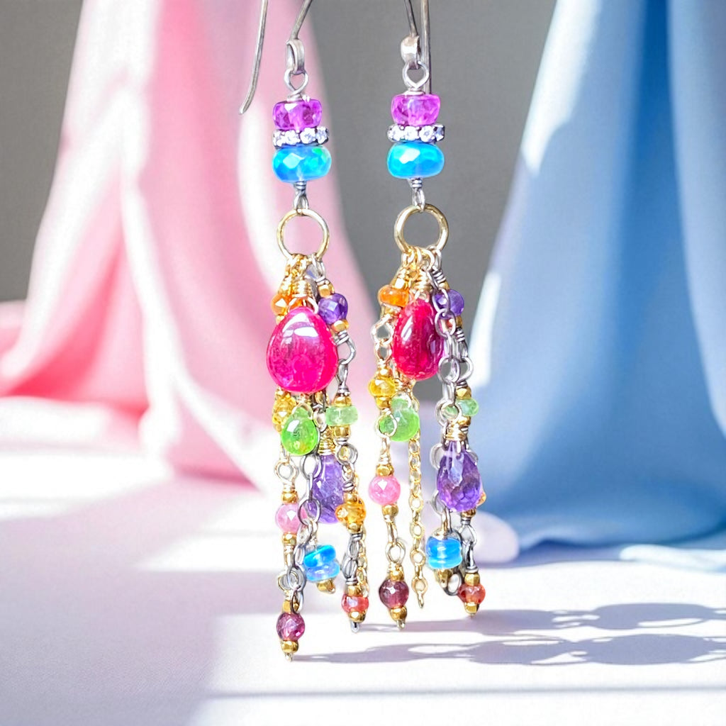 Colorful beaded earrings on a soft fabric background