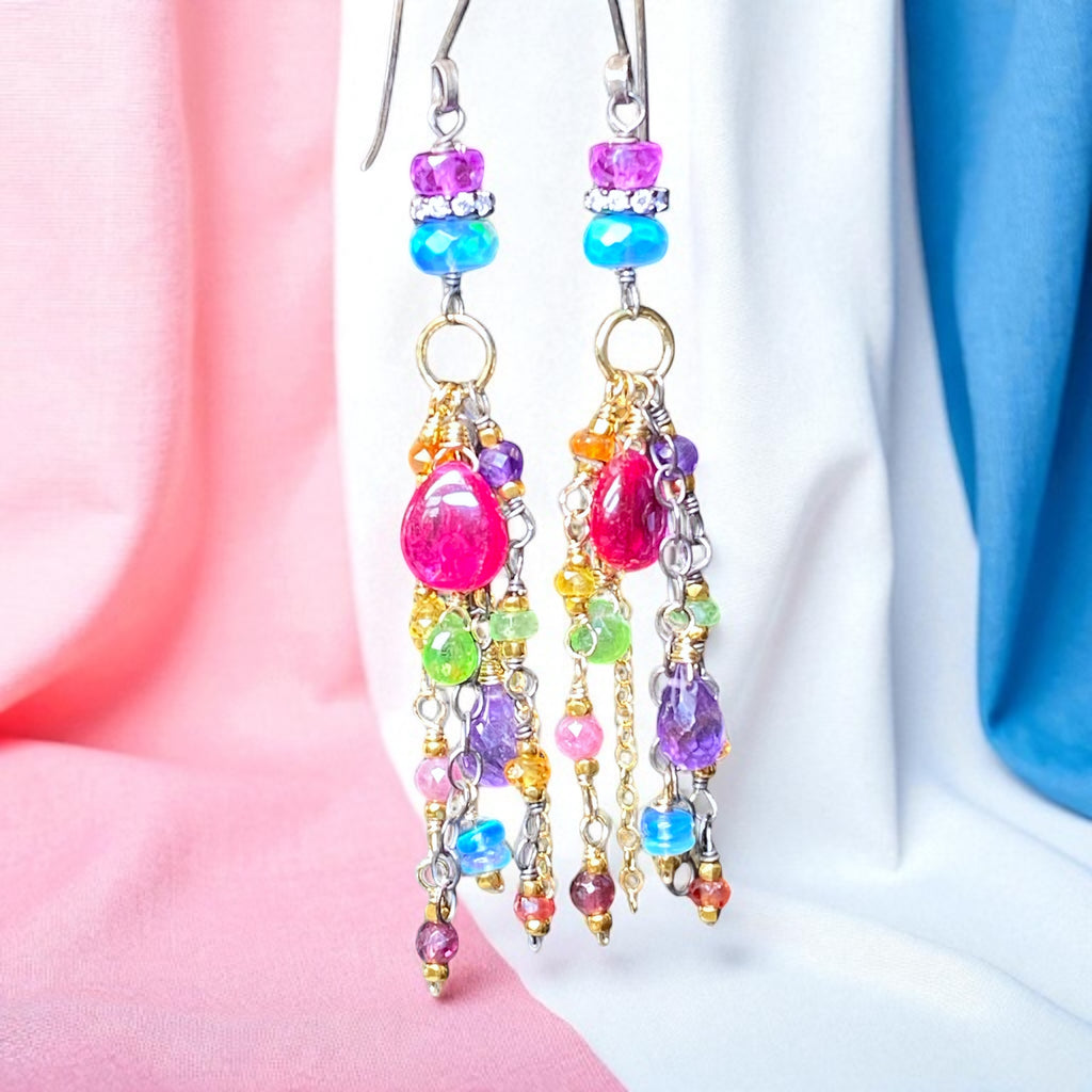 Colorful beaded earrings on a soft pink and blue background