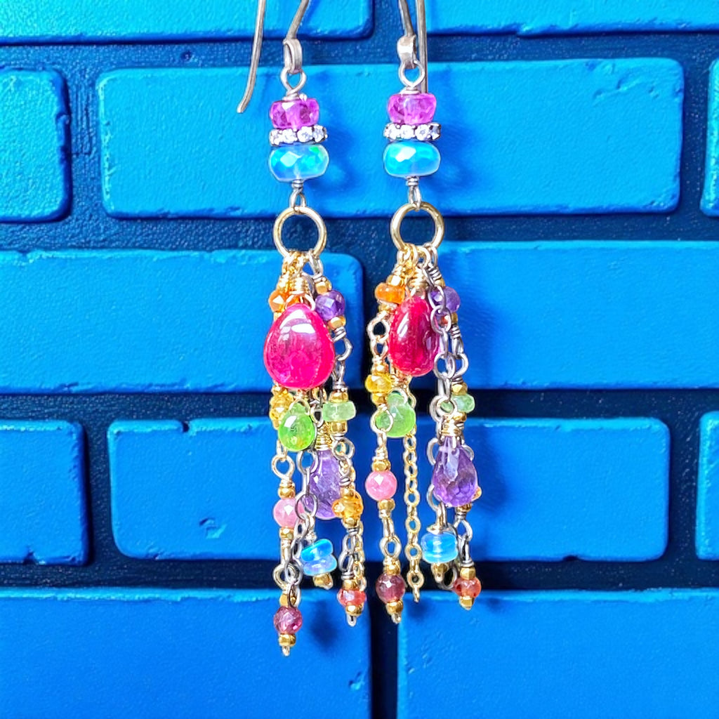 Colorful beaded earrings on a blue brick wall background