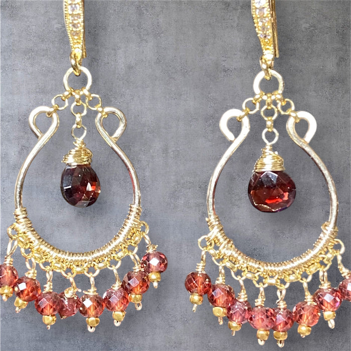 Red garnet chandelier hoop earrings 14kt gold fill dangling against grey suede fabric