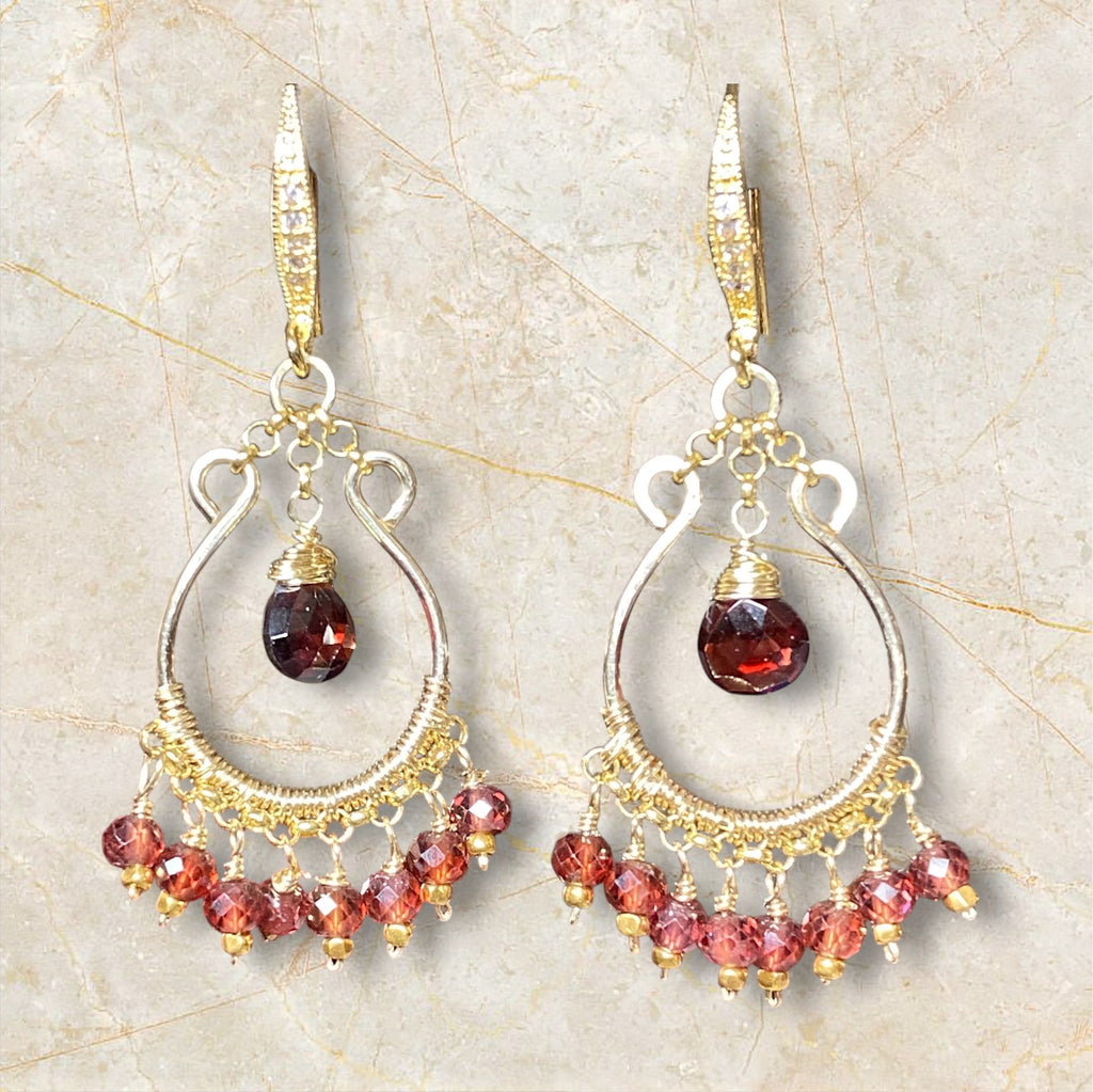 Red garnet chandelier hoop earrings 14kt gold fill dangling against beige marble stone