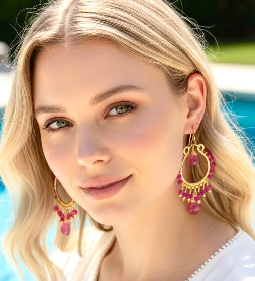 Red ruby pink sapphire gold chandelier hoop earrings on blonde model at pool