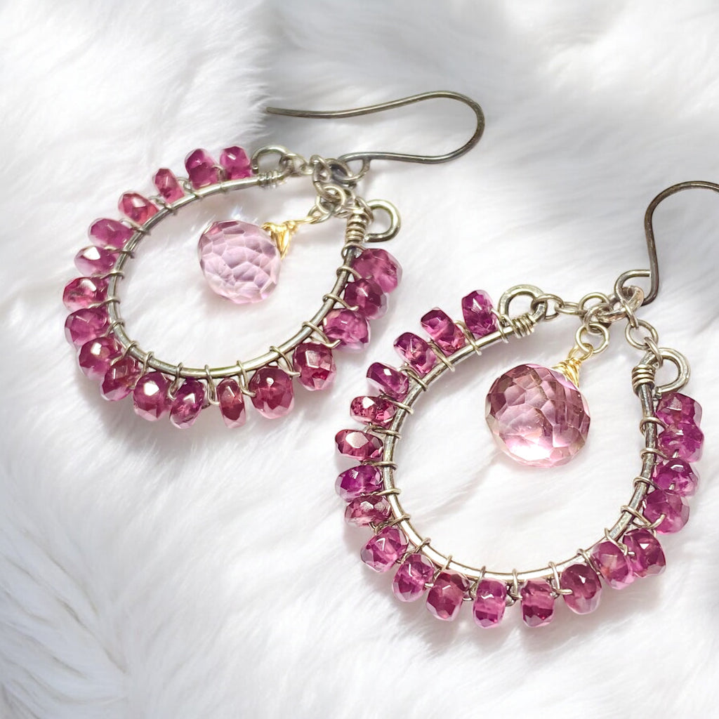 Rhodolite garnet hoop earrings mixed metals mystic plum pink topaz 14kt gold fill oxidized sterling silver lying on furry white fabric