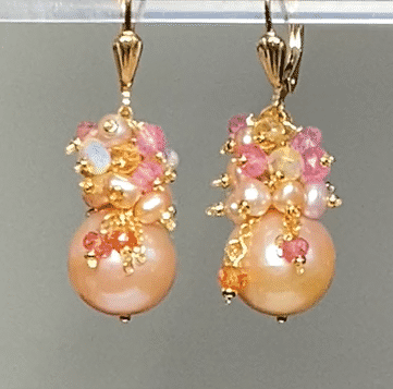 pink round pearls with clusters of more pink pearls and yellow, pink, orange gemstones