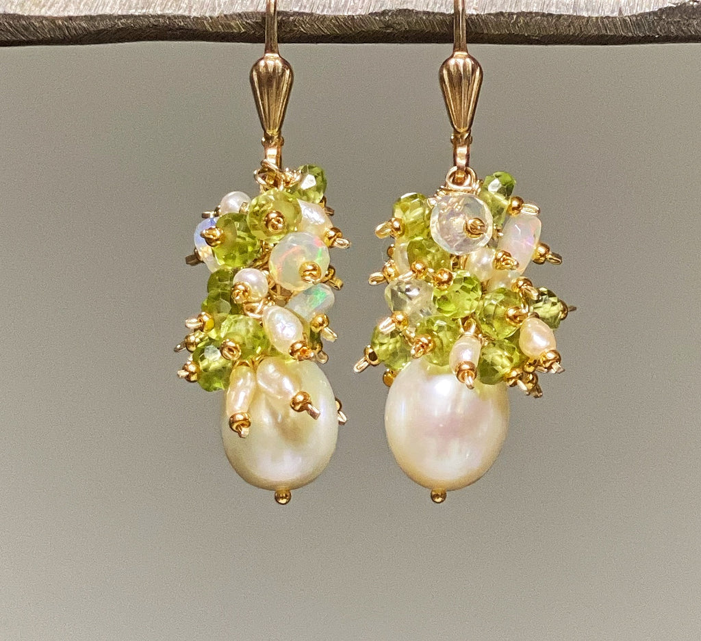 Clusters of peridot rondelles and Ethiopian opals and tiny pearls dangle over freshwater creamy ivory pearls